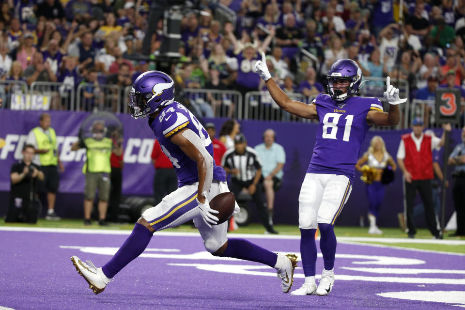 Minnesota Vikings tight end Irv Smith celebrates with teammate Bisi Johnson (81) after catching a 3-yard touchdown pass during the first half of an NFL preseason football game against the Seattle Seahawks, Sunday, Aug. 18, 2019, in Minneapolis. (AP Photo/Bruce Kluckhohn)