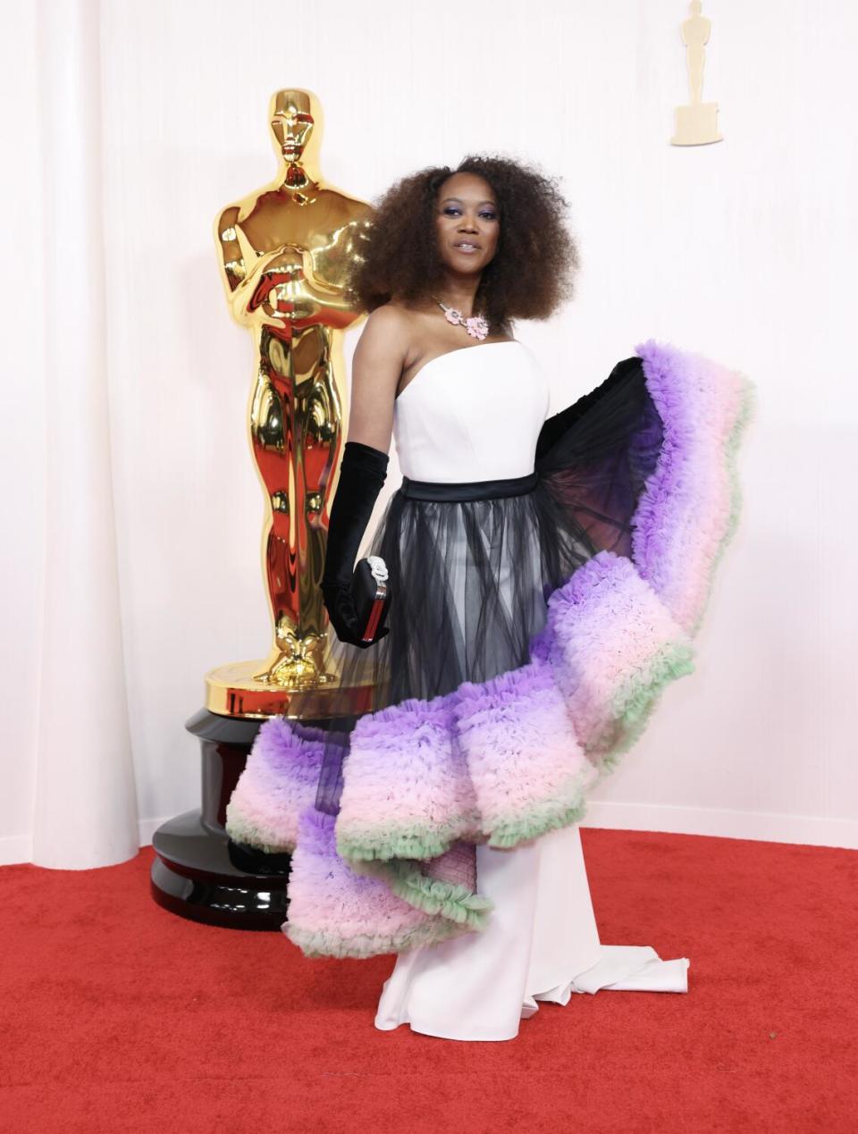 Erika Alexander wears a dress with a colorful ruffled skirt.