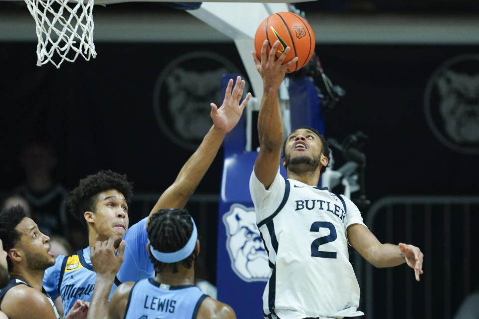 Butler's Aaron Thompson (2) shoots against Marquette's Oso Ighodaro (13) during the second half of an NCAA college basketball game, Saturday, Feb. 12, 2022, in Indianapolis. (AP Photo/Darron Cummings)