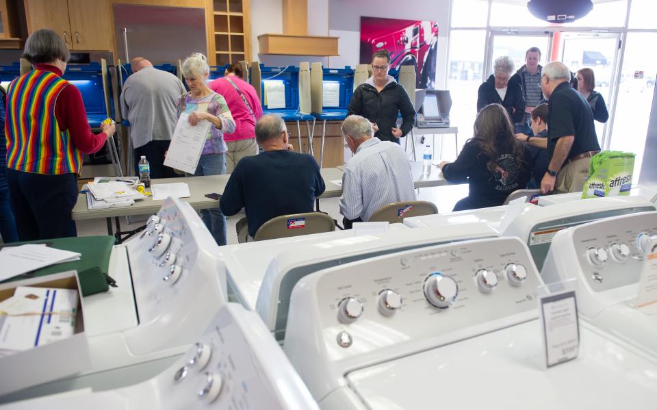 Voters cast their ballots in a polling location inside Mike's TV and Appliance November 8, 2016 in State College, Pennsylvania