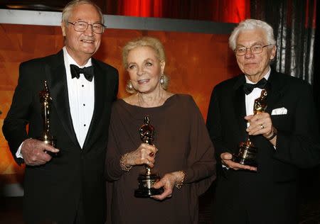 Actress Lauren Bacall (C), cinematographer Gordon Willis (R) and filmmaker Roger Corman pose with their Honorary Oscars at the Academy of Motion Picture Arts & Sciences 2009 Governors Awards in Hollywood, California in this file picture taken November 14, 2009. REUTERS/Fred Prouser/Files