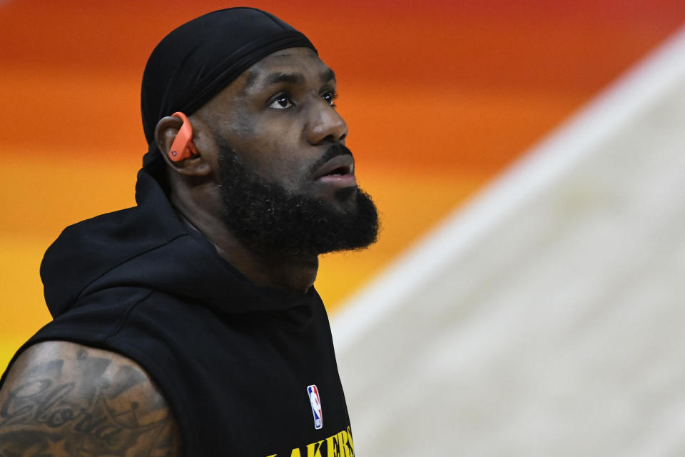 LeBron James wears earpods while warming up before a game.