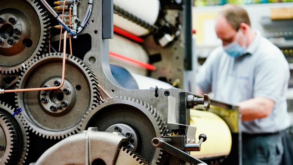 Ein Mitarbeiter montiert ein Druckwerk.