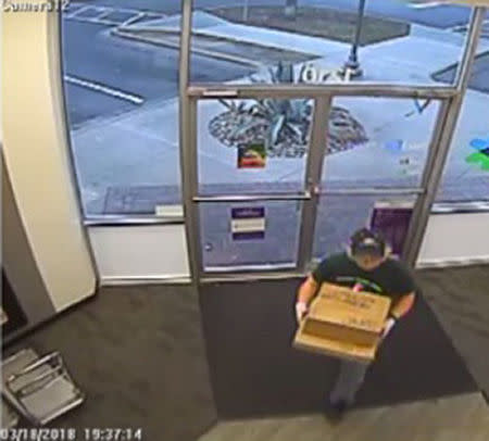 A surveillance image shows the serial bombing suspect entering a FedEx office store in Austin, Texas, U.S., which was given to law enforcement and obtained by TV station, WOAI/KABB, March 21, 2018. Courtesy of WOAI/KABB/Handout via Reuters