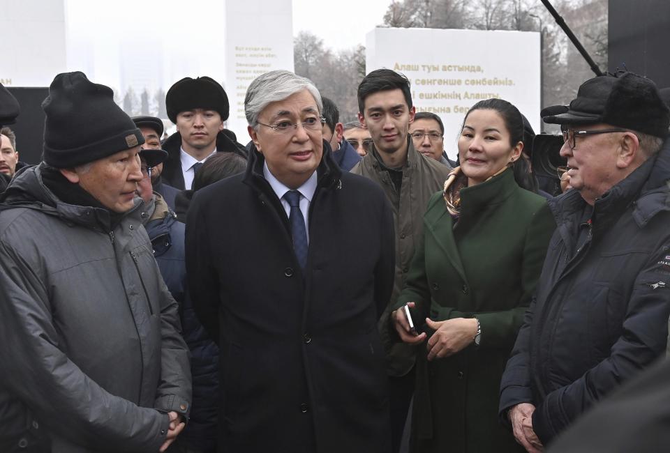 FILE - In this photo released by Kazakhstan's Presidential Press Service, Kazakhstan's President Kassym-Jomart Tokayev speaks to people as he attends an unveiling a memorial to the hundreds of people killed amid the worst unrest in Kazakhstan's three decades of independence in January of 2022 in Republic Square, in the heart of the country's former capital Almaty, Kazakhstan, Friday, Dec. 23, 2022. Words on the stark concrete "Reverence" memorial speak of the need for unity and harmony in the former Soviet country. But a year after calm was restored and a state of emergency lifted on Jan. 20, 2022, both appear elusive in the country of 19 million. (Kazakhstan's Presidential Press Service via AP, File)