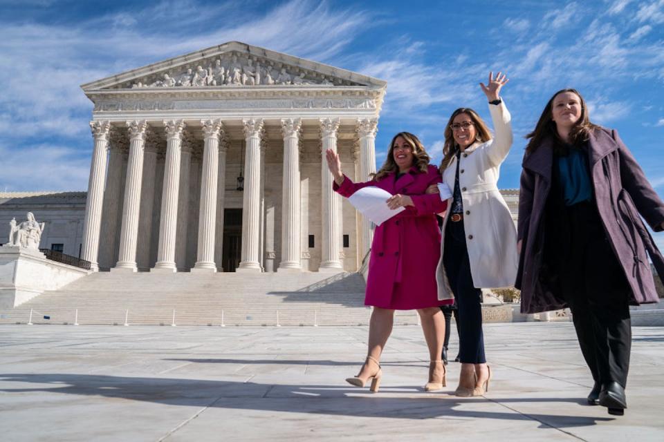 Lorie Smith, left, the owner of 303 Creative, prepares to speak outside the Supreme Court on Dec. 5, 2022. <a href="https://www.gettyimages.com/detail/news-photo/lorie-smith-a-christian-graphic-artist-and-website-designer-news-photo/1245399675?adppopup=true" rel="nofollow noopener" target="_blank" data-ylk="slk:Kent Nishimura / Los Angeles Times via Getty Images;elm:context_link;itc:0;sec:content-canvas" class="link ">Kent Nishimura / Los Angeles Times via Getty Images</a>