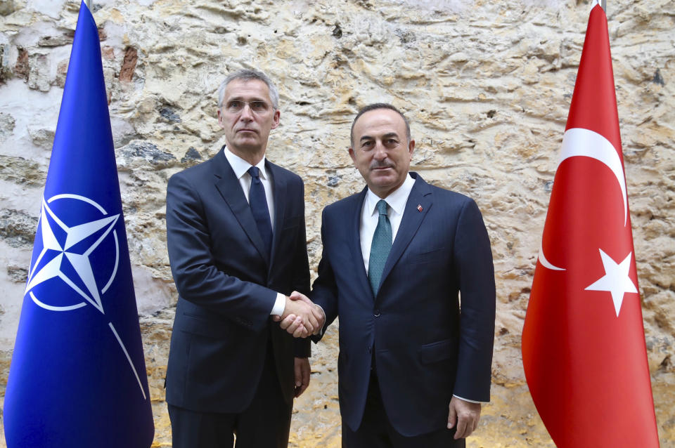 FILE - In this file photo dated Friday, Oct. 11, 2019, Turkish Foreign Minister Mevlut Cavusoglu, right, shakes hands with NATO Secretary General Jens Stoltenberg in Istanbul. The festering dispute between France and Turkey over a naval standoff in the Mediterranean Sea has shone a glaring searchlight on NATO’s struggle to keep order among its ranks, especially when its allies are perceived to be on different sides of a conflict like in Libya. (Turkish Foreign Ministry file via AP)