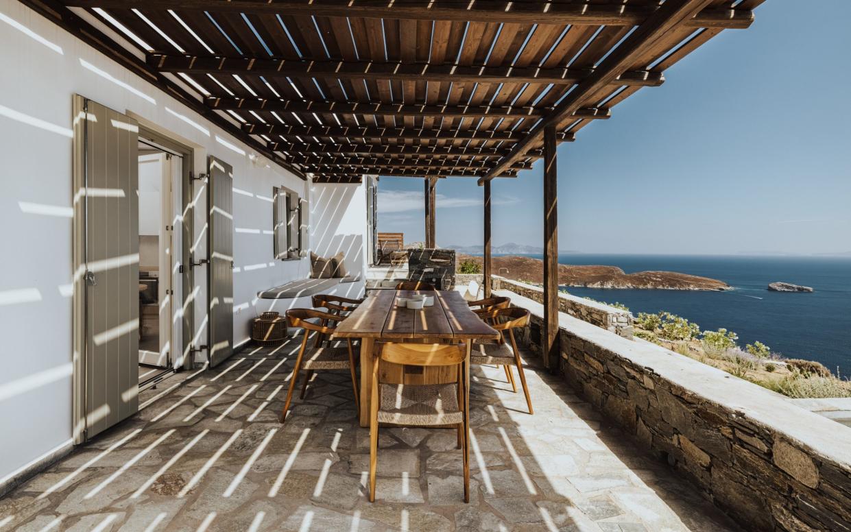 Wooden-awning over a balcony with a dining table