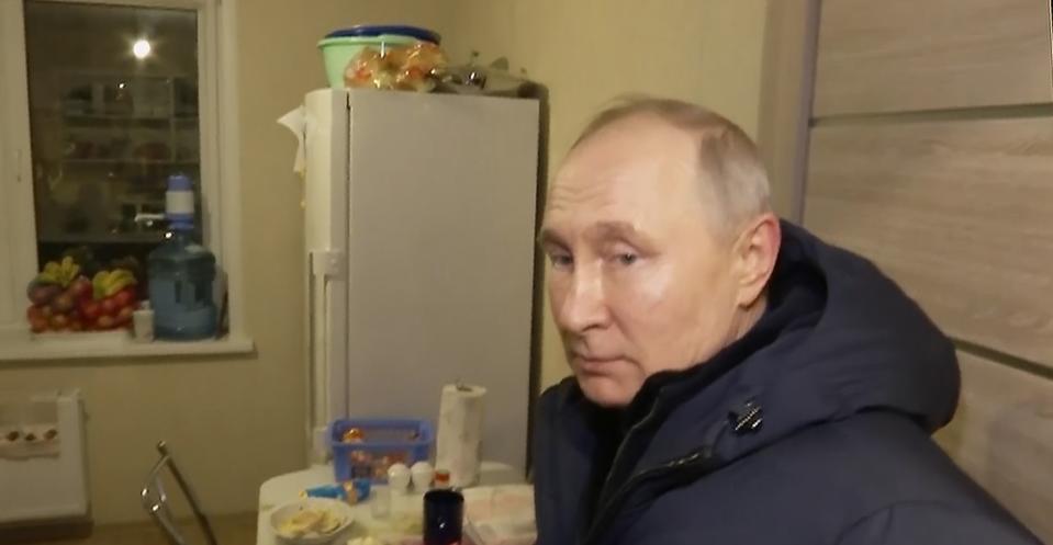 In this photo taken from video released by Russian TV Pool on Sunday, March 19, 2023, Russian President Vladimir Putin listens to local residents at their new flat during his visit to Mariupol in Russian-controlled Donetsk region, Ukraine. Putin has traveled to Crimea to mark the ninth anniversary of the Black Sea peninsula's annexation from Ukraine. (Pool Photo via AP)