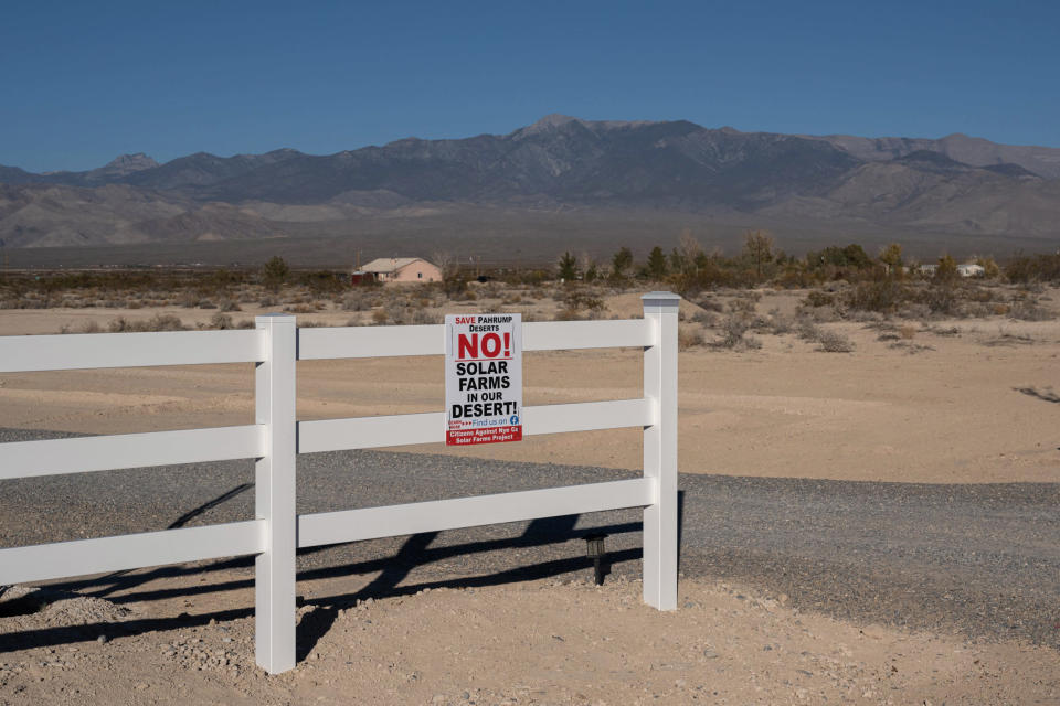 A residence displays a sign opposing solar projects in Pahrump, Nev., on Nov. 27, 2021. Candela Renewables, a San Francisco-based renewable energy company, hopes to build a large-scale solar field across some 2,300 acres bordering Pahrump. (Bridget Bennett for NBC News)
