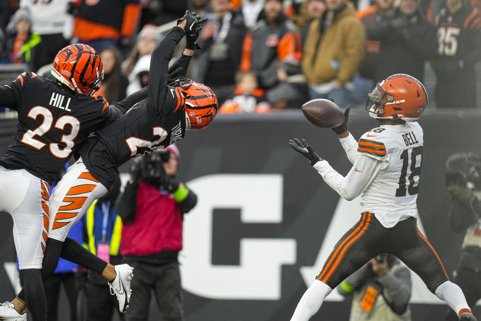 Cleveland Browns wide receiver David Bell (18) makes a catch for a touchdown behind Cincinnati Bengals safety Dax Hill (23) and cornerback DJ Turner II (20) in the second half of an NFL football game in Cincinnati, Sunday, Jan. 7, 2024. (AP Photo/Sue Ogrocki)