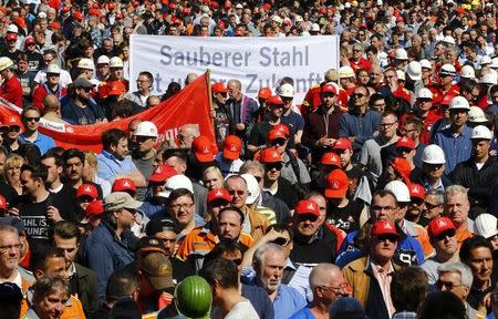 Steel workers of Germany's industrial conglomerate ThyssenKrupp AG and IG Metall union members demonstrate for higher wages in Duisburg, Germany April 11, 2016. The text on banner reads 'Cleaner steel is the future'. REUTERS/Wolfgang Rattay