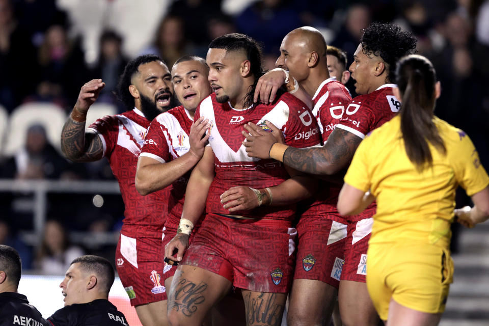 Tonga's Keaon Koloamatangi, center, celebrates scoring a try with teammates during the Rugby League World Cup group D match between Wales and Tonga at the Totally Wicked Stadium, St Helens, England, Monday Oct. 24, 2022. (Richard Sellers/PA via AP)