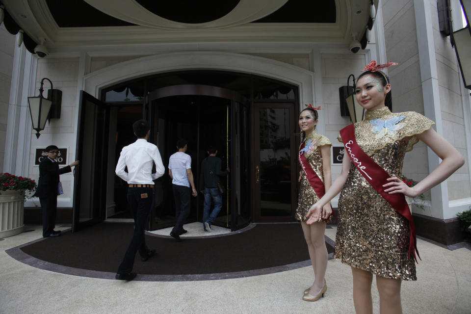 In this April 21, 2010 photo attendants welcome customers to the casino of Wynn Encore Macau, the newest resort built by Steve Wynn. Macau is in the midst of one of the greatest gambling booms the world has ever known. To rival it, Las Vegas would have to attract six times as many visitors essentially every man, woman and child in America. Wynn Las Vegas now makes nearly three-quarters of its profits in Macau. Sands, which owns the Venetian and Palazzo, earns two-thirds of its revenue there. (AP Photo/Kin Cheung)