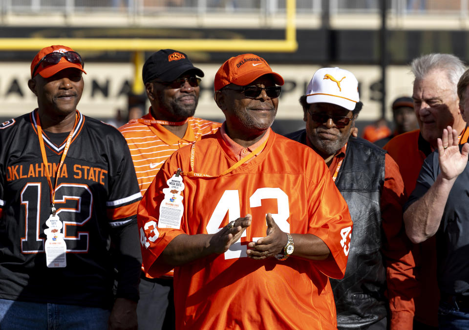 FILE - Terry Miller (43) celebrates with friends and family at half time as he is inducted into the Oklahoma State Ring of Honor during an NCAA college football game against Kansas in Stillwater, Okla., Oct. 14, 2023. Oklahoma and Oklahoma State will meet on Saturday for the final time before Oklahoma leaves the Big 12 for the Southeastern Conference. (AP Photo/Mitch Alcala, File)