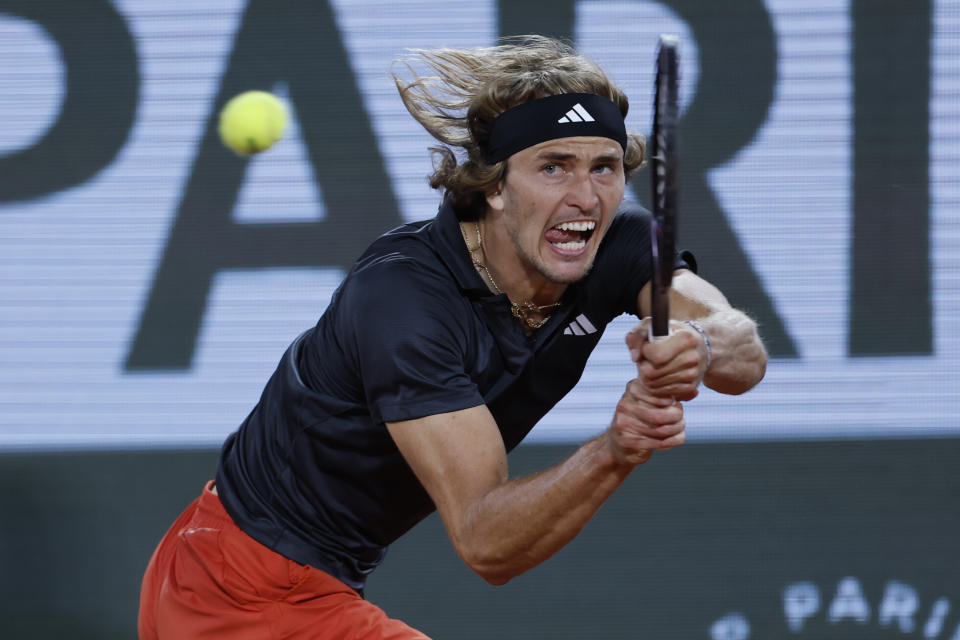 Germany's Alexander Zverev returns the ball to Frances Tiafoe of the U.S. during their third round match of the French Open tennis tournament at the Roland Garros stadium in Paris, Saturday, June 3, 2023. (AP Photo/Jean-Francois Badias)