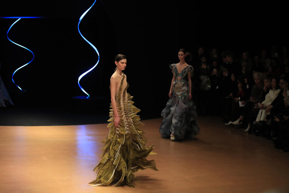 Models wear creations for Iris van Herpen Haute Couture Spring/Summer 2020 fashion collection presented Monday Jan.20, 2020 in Paris (AP Photo/Michel Euler)