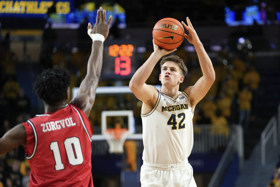 Michigan forward Will Tschetter (42) shoots as Youngstown State center Imanuel Zorgvol (10) defends in the second half of an NCAA college basketball game in Ann Arbor, Mich., Friday, Nov. 10, 2023. (AP Photo/Paul Sancya)