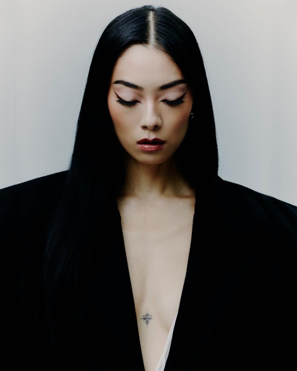 Rina Sawayama by Ethan Hart for ES magazine | SAINT LAURENT  coat, £3,610;  dress, £4,445  (ysl.com). CARTIER  Juste un Clou  white gold  earrings, £2,660  (cartier.com) (Rina Sawayama by Ethan Hart for ES magazine | SAINT LAURENT  coat, £3,610;  dress, £4,445  (ysl.com). CARTIER  Juste un Clou  white gold  earrings, £2,660  (cartier.com))