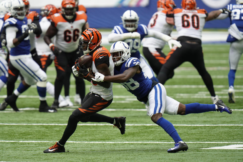 Cincinnati Bengals' A.J. Green (18) is tackled by Indianapolis Colts' T.J. Carrie (38) during the second half of an NFL football game, Sunday, Oct. 18, 2020, in Indianapolis. (AP Photo/AJ Mast)