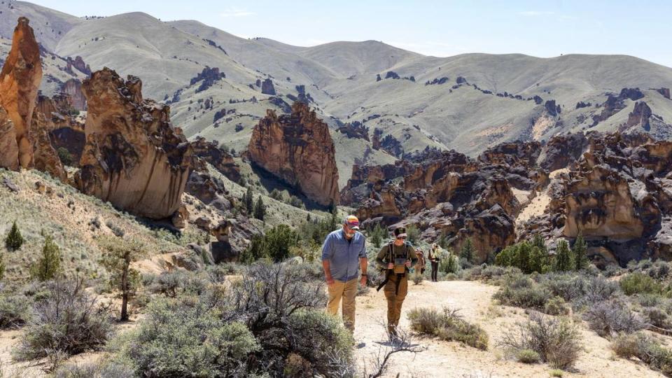 Michael Gibson, Southeast Oregon field coordinator for Trout Unlimited, left, and Skyler Vold, a sage grouse conservation expert with Oregon Department of Fish and Wildlife, hike Juniper Gulch in the Owyhee Canyonlands. Vold counted 22 sage grouse at a lek on a recent tour, a record for that spot.