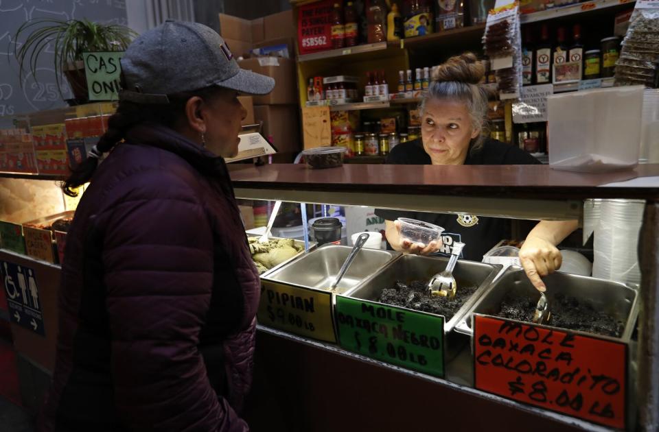 A customer stands at a display case.