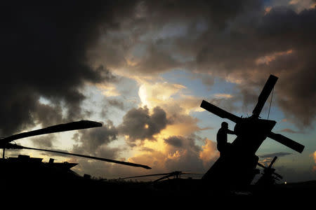 Sergeant First Class Eladio Tirado, who is from Puerto Rico, inspects the rear rotor of a UH-60 Blackhawk helicopter from the First Armored Division's Combat Aviation Brigade during recovery efforts following Hurricane Maria, in Roosevelt Roads Naval Station, Puerto Rico, October 7, 2017. REUTERS/Lucas Jackson