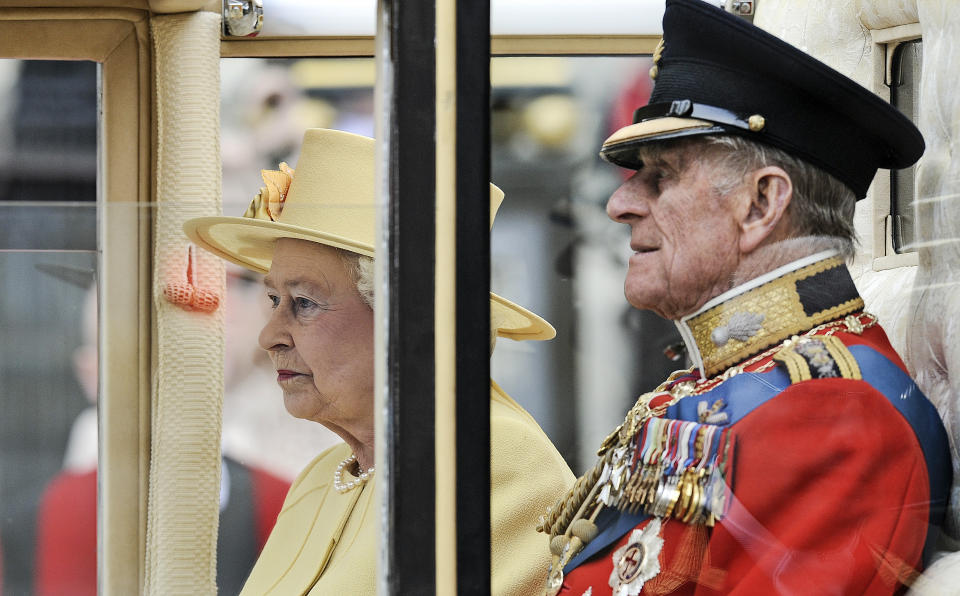 FILE - In this April 29, 2011 file photo, Britain's Prince Phillip sits beside Queen Elizabeth II in a carriage leaving Westminster Abbey after the Royal Wedding of Prince William and Kate Middleton in London. Prince Philip, the irascible and tough-minded husband of Queen Elizabeth II who spent more than seven decades supporting his wife in a role that both defined and constricted his life, has died, Buckingham Palace said Friday. He was 99. (AP Photo/Martin Meissner, File)