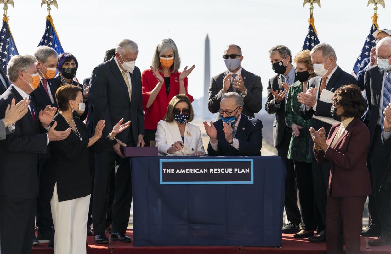 <span class="caption">Democrats celebrate passing the first big legislation of the Biden presidency.</span> <span class="attribution"><a class="link " href="https://newsroom.ap.org/detail/VirusOutbreakCongress/c46ebad82fdb43c6905e3ca84ba48c85/photo?Query=1.9%20trillion&mediaType=photo&sortBy=arrivaldatetime:desc&dateRange=Anytime&totalCount=298&currentItemNo=1" rel="nofollow noopener" target="_blank" data-ylk="slk:AP Photo/Alex Brandon;elm:context_link;itc:0;sec:content-canvas">AP Photo/Alex Brandon</a></span>