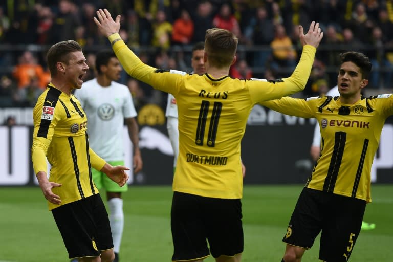 Dortmund's Polish defender Lukasz Piszczek and his teammates celebrate during their Bundesliga match against VfL Wolfsburg in Dortmund on February 18, 2017