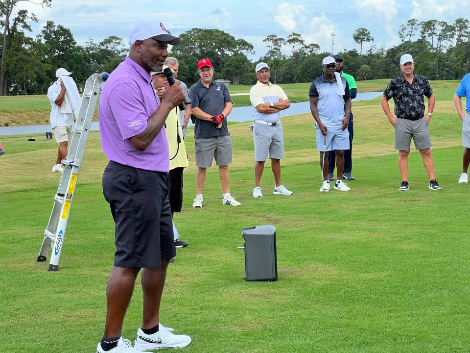 Derrick Brooks addresses celebrity players and area participants on the practice range at Pensacola Country Club on Monday, Aug. 9 in the Derrick Brooks Charities Golf Tournament.