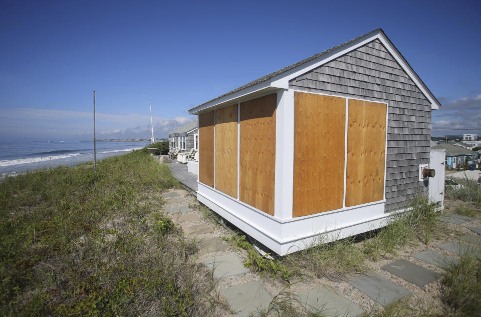 A beach house on East Matunuck beach in South Kingstown, R.I., is boarded up in preparation for Hurricane Henri Saturday, Aug. 21, 2021. New Englanders, bracing for their first direct hit by a hurricane in 30 years, are taking precautions as Tropical Storm Henri barrels toward the southern New England coast. (AP Photo/Stew Milne)