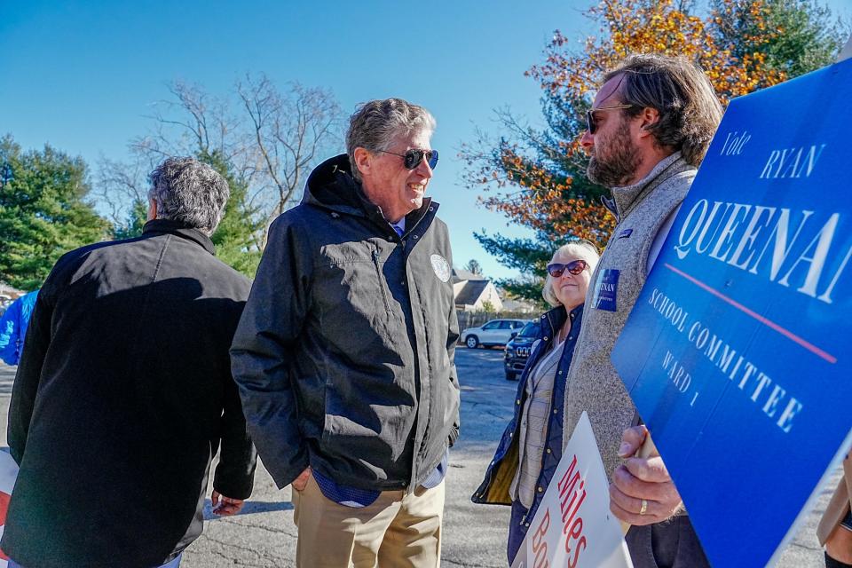 Gov. Dan McKee chats with Ryan Queenan outside a polling station in East Providence.