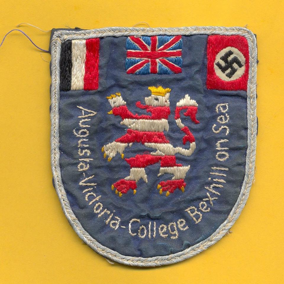 Fabric badge with flags on it and the name of the college