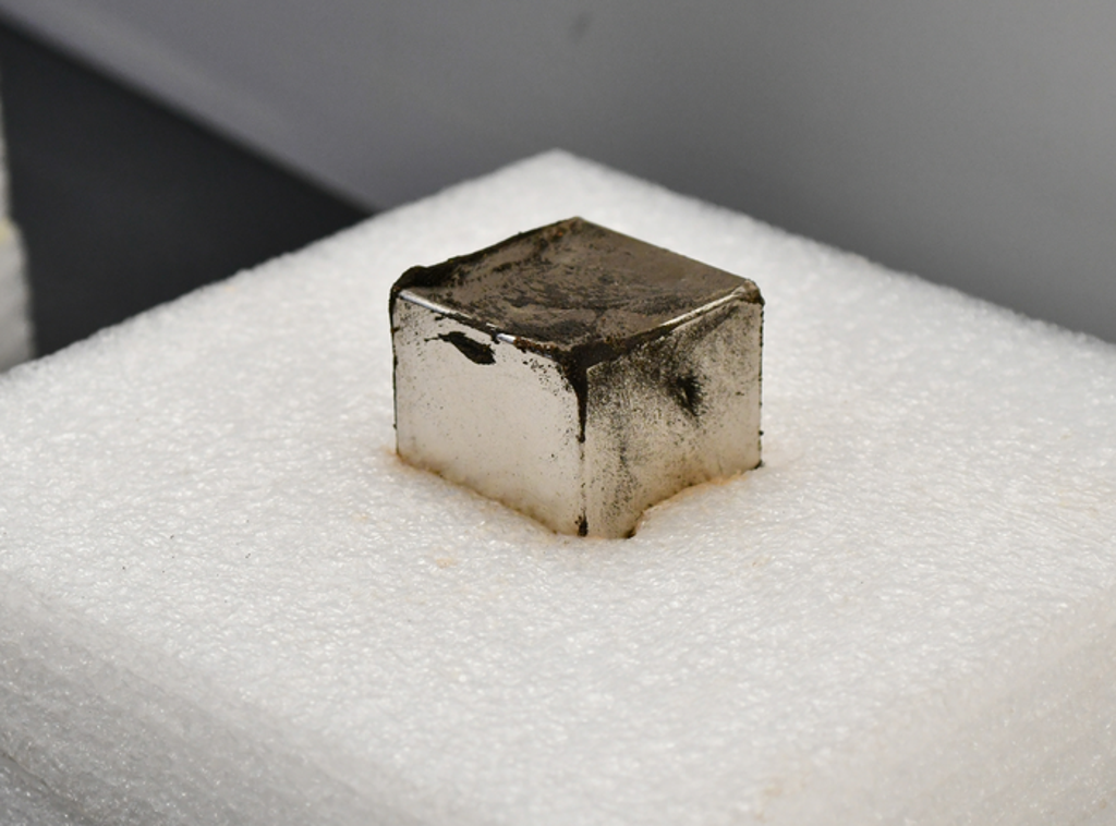 Magnet holds tiny micrometeorites collected from sediment samples taken from an ancient Hopewell site (Michael Miller)