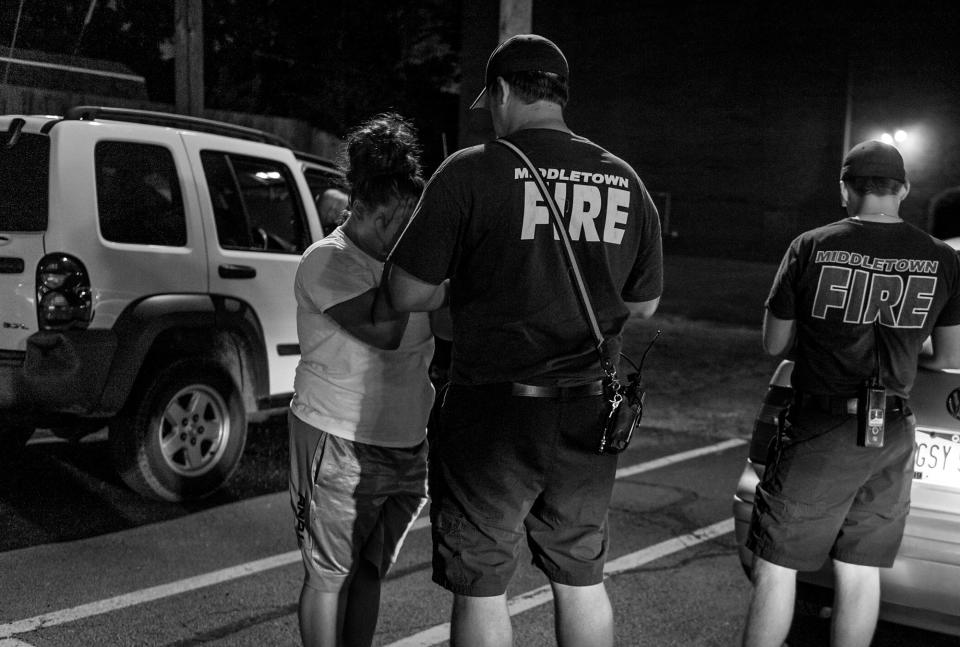 The Middletown Fire Department responds to a call about a young woman possibly overdosing on heroin. “You’re not going to get in trouble:” A fireman tries to convince her to go to the hospital. (Photograph by Mary F. Calvert for Yahoo News)