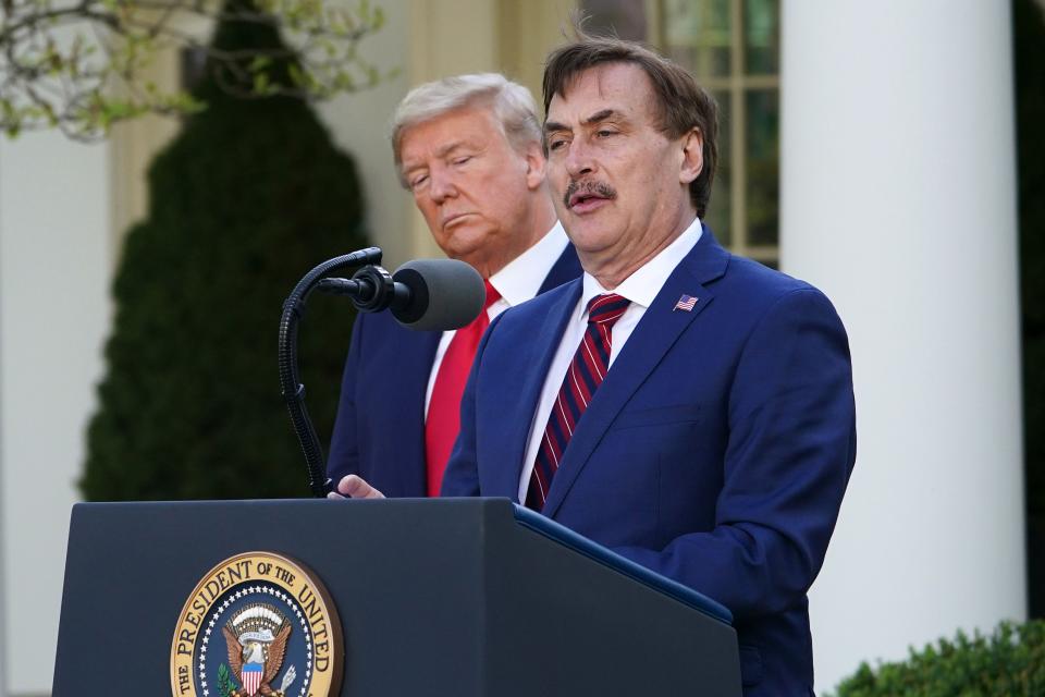 President Donald Trump listens to Michael Lindell, CEO of MyPillow Inc., in the White House Rose Garden on March 30, 2020.