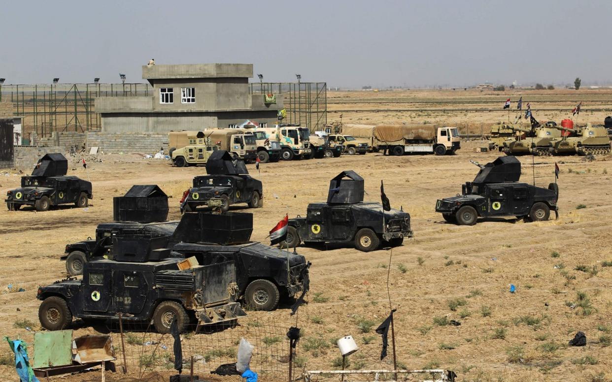 Iraqi forces gather in the area of Taza Khurmata on the southern outskirts of Kirkuk on October 15 - AFP