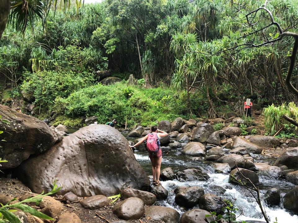Hikers are pictured near Hanakapi’ai Beach, where water falling from Hanakāpī‘ai Falls poses a challenge on May 20, 2022.