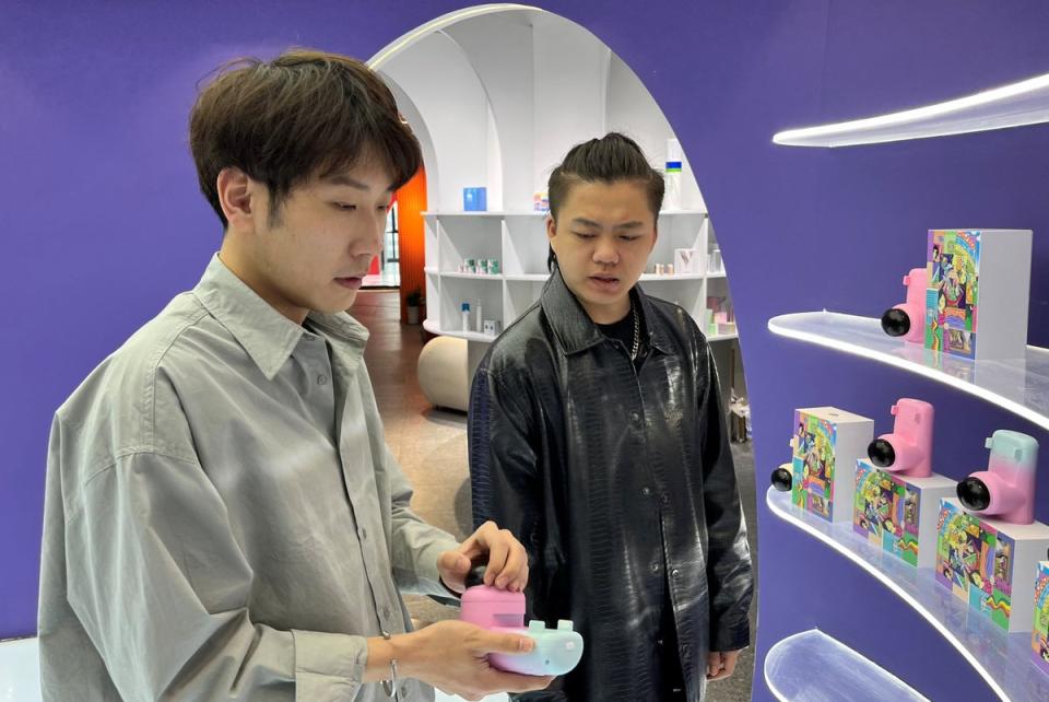 Zhao Jianbo, founder of the remote kissing device “Long Lost Touch” demonstrates products for the camera during an interview with Reuters, at an office in Hangzhou, Zhejiang (REUTERS)