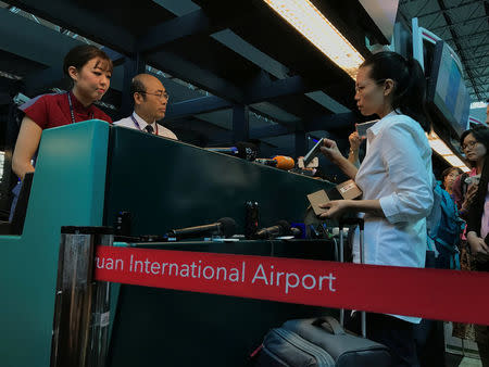 Li Ching-yu (R), a wife of Taiwanese human rights activist Li Ming-che, detained in China, tries to check-in at Taoyuan International Airport, Taiwan, April 10, 2017. REUTERS/Fabian Hamacher