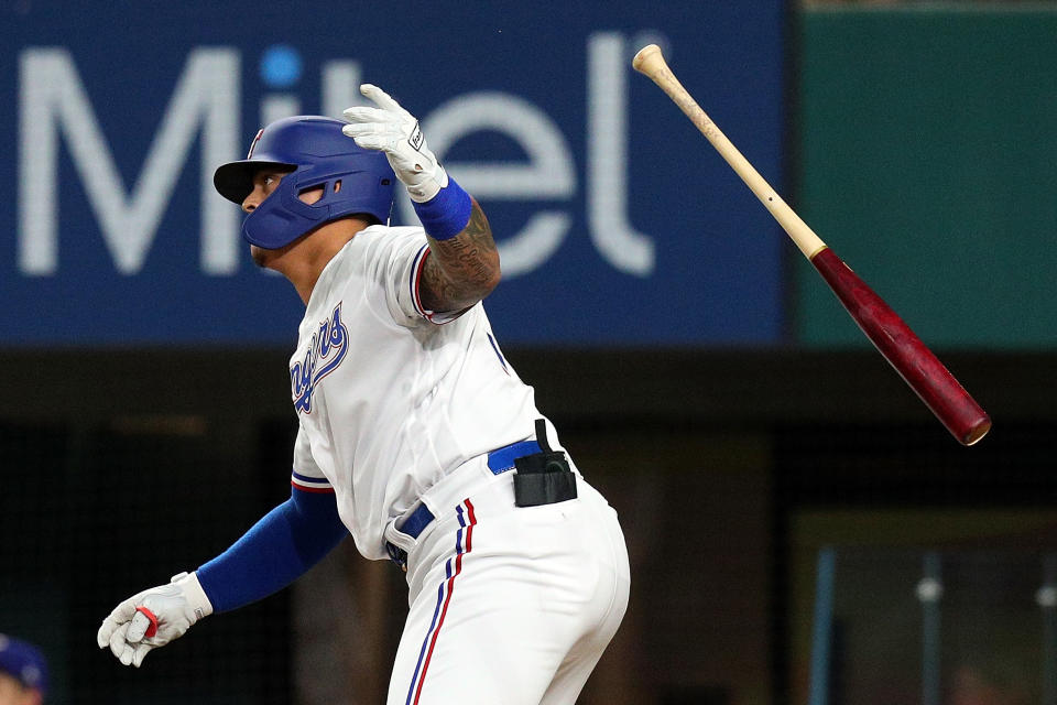ARLINGTON, TEXAS - AUGUST 14: Yohel Pozo #37 of the Texas Rangers flips his bat after hitting a single in the fifth inning against the Oakland Athletics at Globe Life Field on August 14, 2021 in Arlington, Texas. (Photo by Richard Rodriguez/Getty Images)