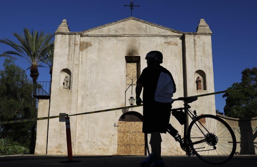 SAN GABRIEL-CA-JULY 12, 2020: A bicyclist stops in front of the historic 249-year-old San Gabriel Mission on Sunday, July 12, 2020. A fire early Saturday caused "extensive damage". (Christina House / Los Angeles Times)