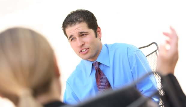 Young businessman interviewing woman