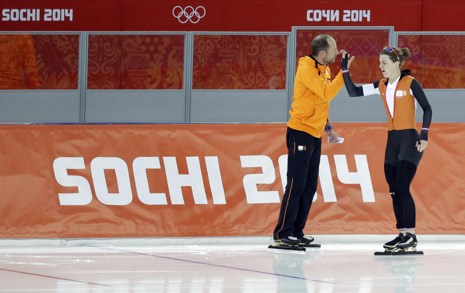 Ireen Wust of the Netherlands greets her coach Gerard Kemkers after competing in the women's 3,000-meter speedskating race at the Adler Arena Skating Center during the 2014 Winter Olympics, Sunday, Feb. 9, 2014, in Sochi, Russia. (AP Photo/Pavel Golovkin)