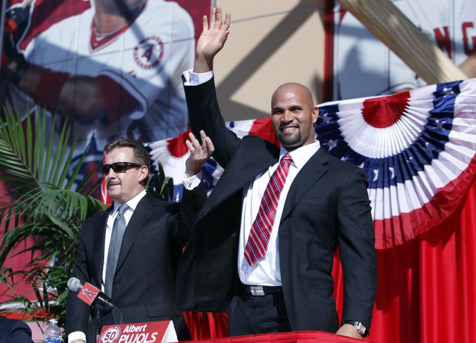 Angels owner Arte Moreno, left, introduces Albert Pujols at a news conference Dec. 10, 2011, at Angel Stadium.