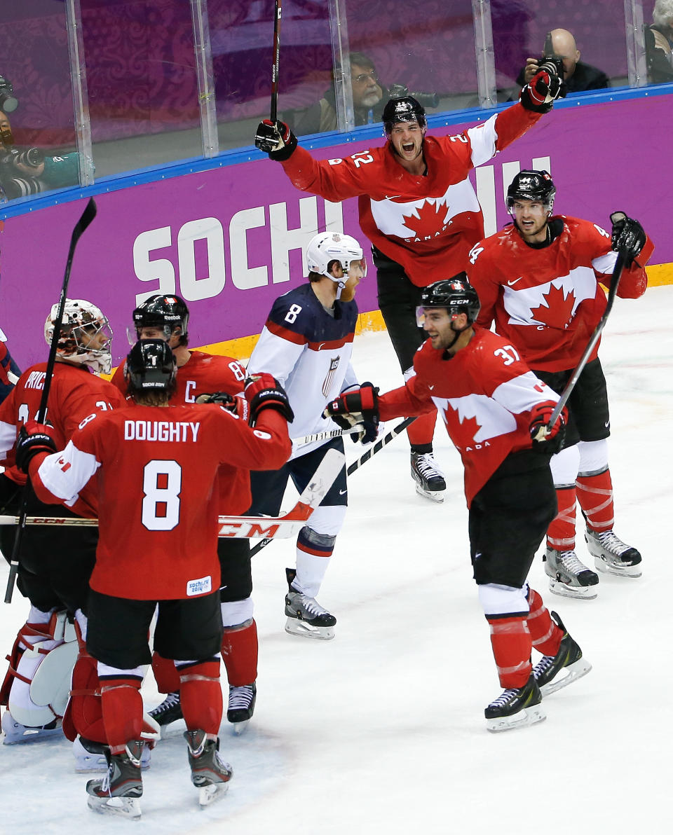 Canada celebrates their 1-0 victory over Team USA in the men's semifinal ice hockey game at the 2014 Winter Olympics, Friday, Feb. 21, 2014, in Sochi, Russia. (AP Photo/Matt Slocum)