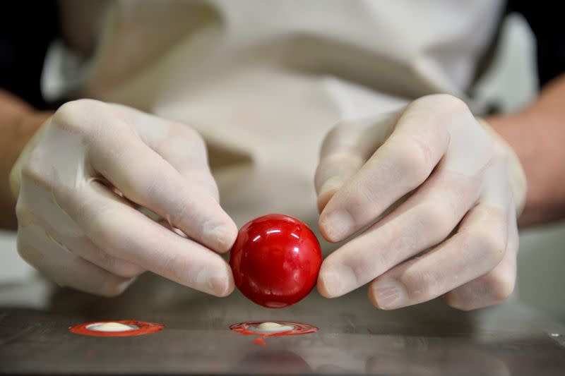 A worker prepares a pastry at the workshop of Belgian chocolate maker Marcolini, in Brussels