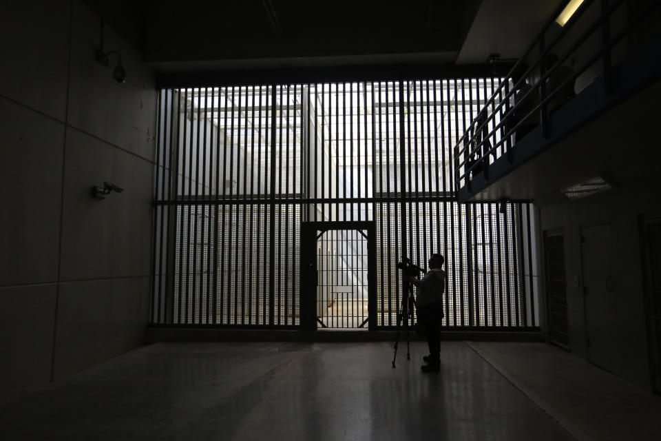 FILE - A journalist films the now closed Laguna del Toro maximum security facility during a media tour of the former Islas Marias penal colony located off Mexico's Pacific coast, Saturday, March 16, 2019. Bars and cells were limited to the maximum security facility because the surrounding ocean effectively prevented escape. resident Andrés Manuel López Obrador had the facility converted into an environmental education center. Now the government wants to make it an ecotourism destination where visitors can watch sea birds and enjoy the beaches. (AP Photo/Rebecca Blackwell, File)