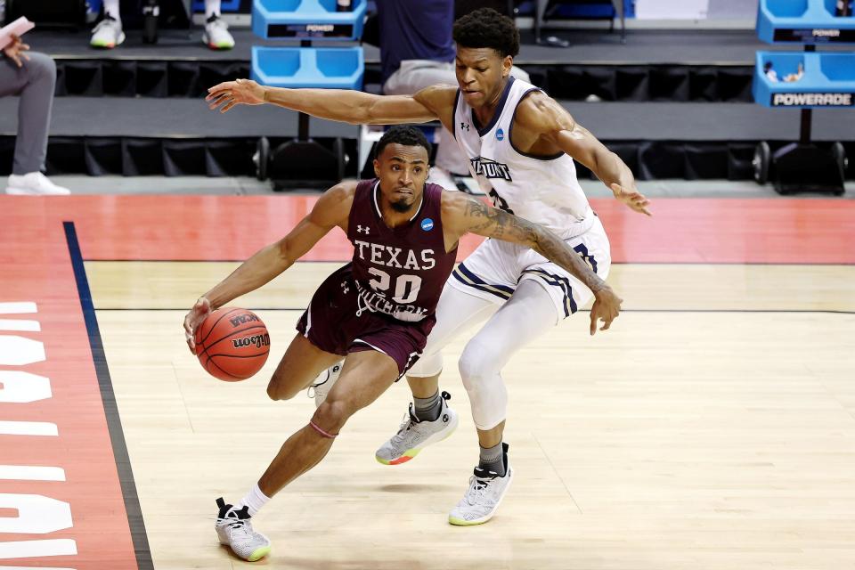 Mar 18, 2021; Bloomington, Indiana, USA; Texas Southern Tigers guard Michael Weathers (20) dribbles past Mount St. Mary's Mountaineers forward Mezie Offurum (13) during the first half in the First Four of the 2021 NCAA Tournament at Simon Skjodt Assembly Hall.